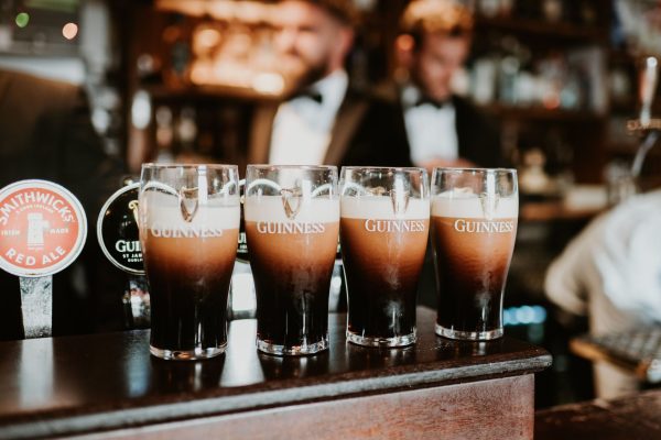 Close-up of four Guinness pints settling beside the taps at Johnnie Fox’s bar