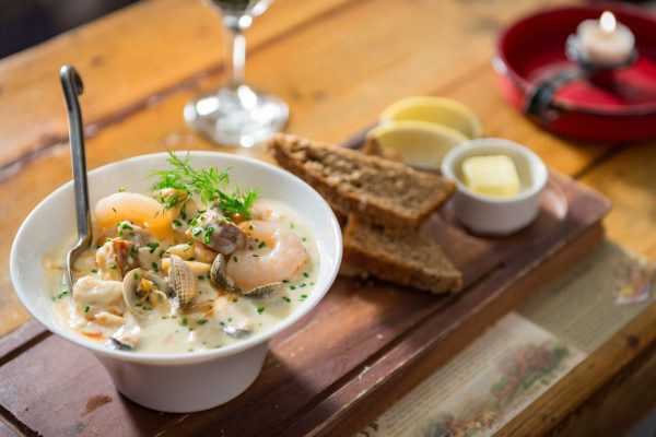 Bowl of creamy seafood chowder with prawns, clams, and herbs at Johnnie Fox’s