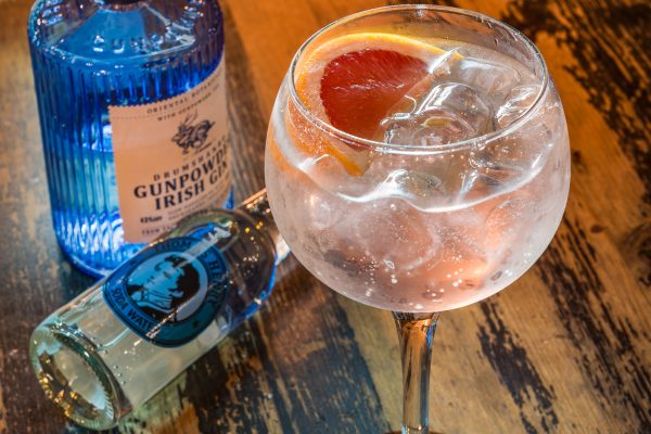 Gunpowder Irish gin cocktail served with soda water and grapefruit in a large gin glass at Johnnie Fox’s.
