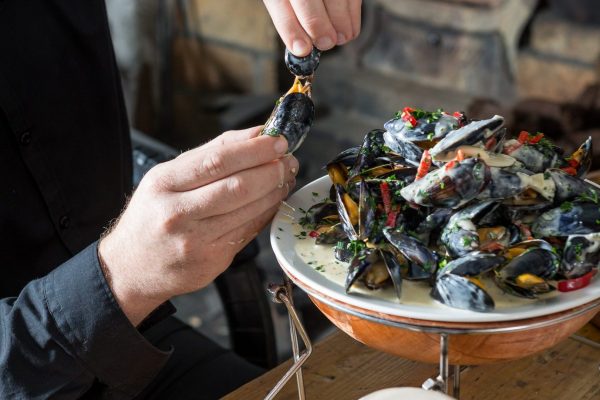 Fresh mussels in cream sauce being plated at Johnnie Fox’s