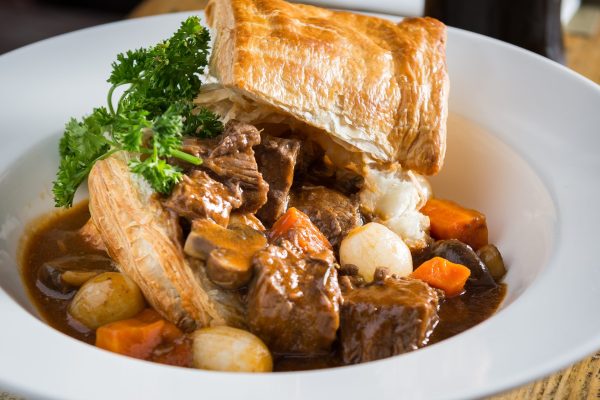 Beef stew with vegetables served in a white bowl at Johnnie Fox’s.