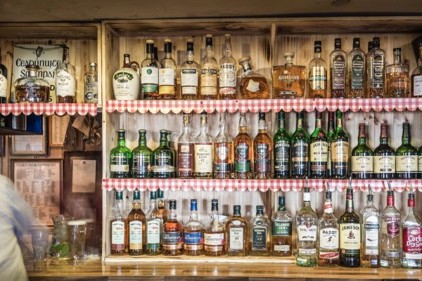 Whiskey bar shelves at Johnnie Fox’s Pub, featuring Irish whiskey brands.